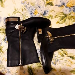 Vince Camuto boots. Black leather uppers. Gold trim. Outside zipper.